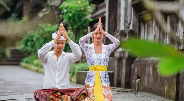 Two Balinese hindus praying