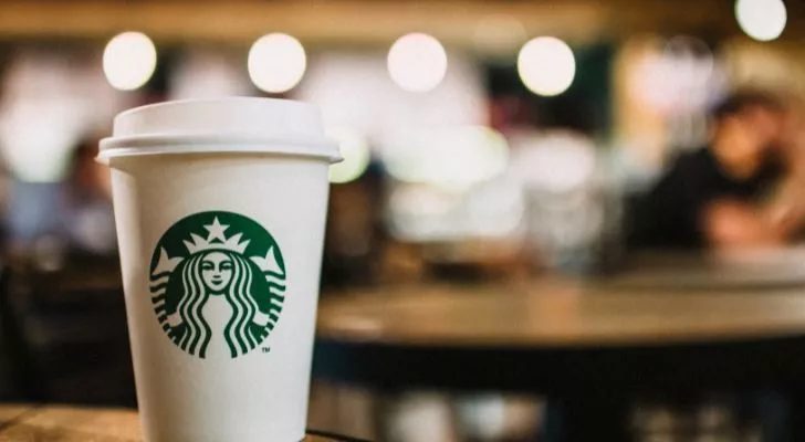 A Starbucks coffee cup in a coffee shop