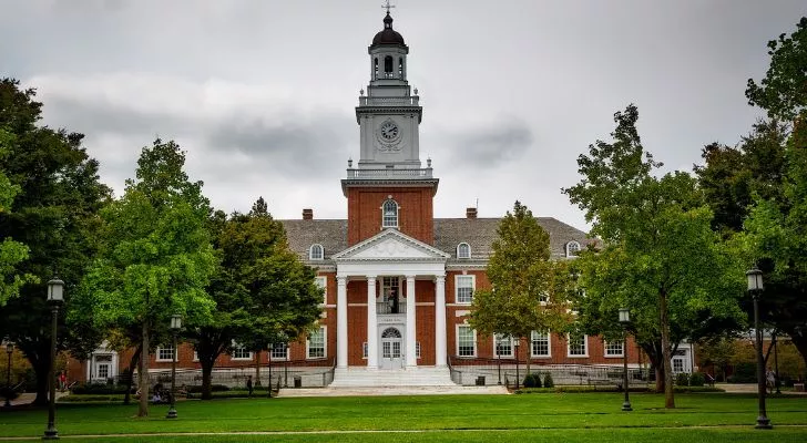 A university building surrounded by trees