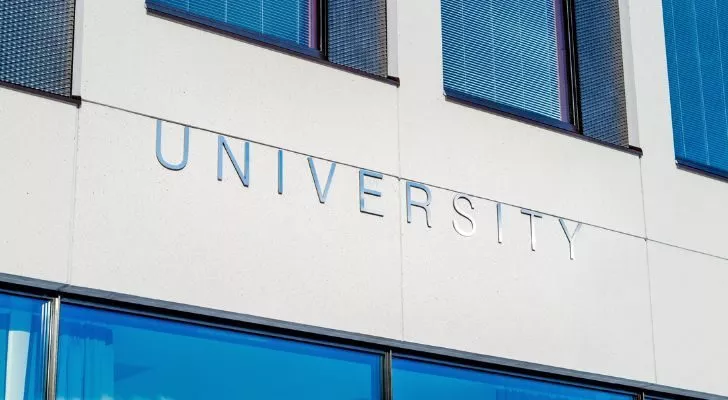 A sign reading "University" on the side of a building
