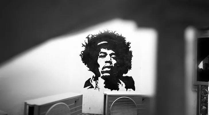 Art of Jimi Hendrix on a wall above some speakers