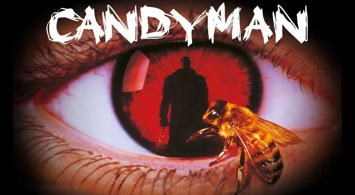 The word candyman written above an eye with a red iris. The eye's pupil is the silhouette of a man and there is a bee on the eye.
