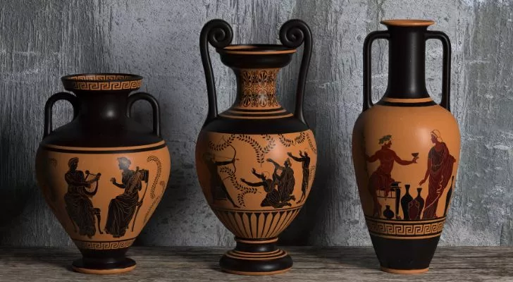Ancient Greek amphorae (clay wine vessels) of different sizes with stories depicted on their sides
