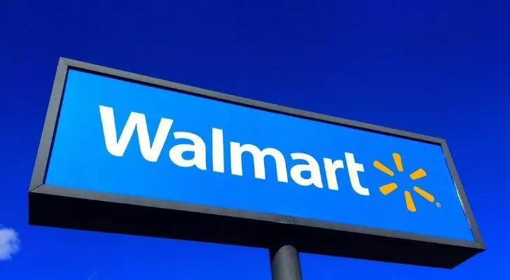 A large blue Walmart sign against a blue sky