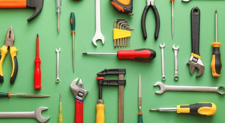 Assorted tools arranged on a green background