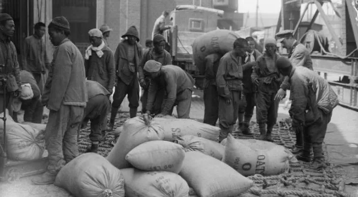 Chinese labourers move sandbags around