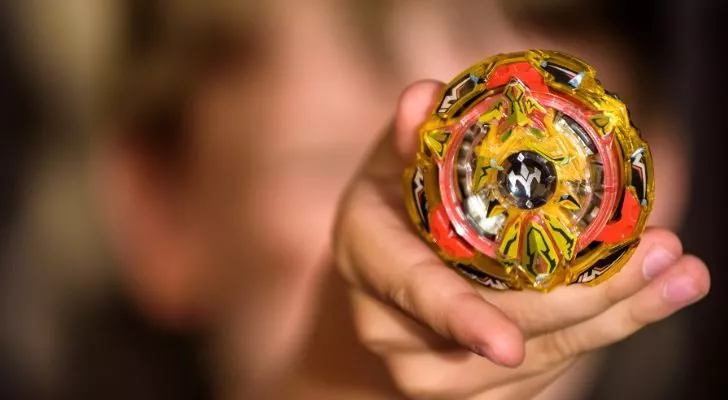 A child presents his Beyblade