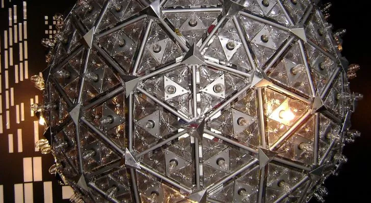 A large silver ball constructed with a metal frame, covered in lights