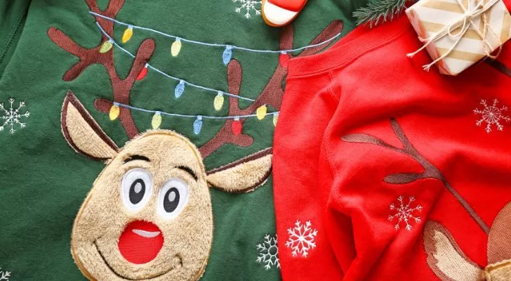 Two ornate Christmas sweaters with reindeers on their front