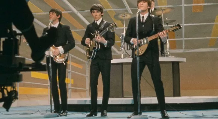 The Beatles performing a song on a TV show stage