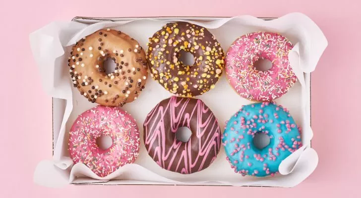 Six colorful donuts arranged in a box