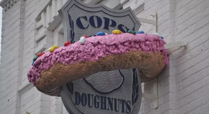 A sign for a donut shop called "Cops and Doughnuts"