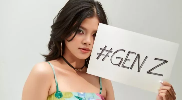 A woman holding up a sign saying "# GEN Z"