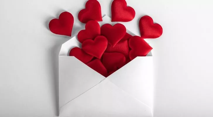 An envelope with hearts spilling out of it