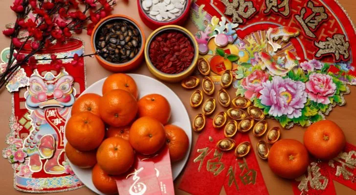 A variet of items associated with Chinese New Year, including sweets and mandarins.