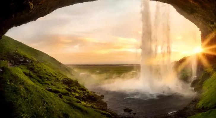 A view of a waterfall in Iceland during sunset