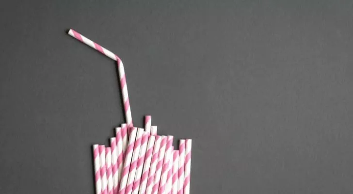 A collection of white and pink striped paper straws
