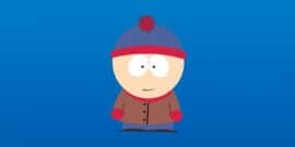 Stan Marsh from South Park wearing his iconic blue and red beanie, brown jacket, red mittens, and blue pants against a blue background.
