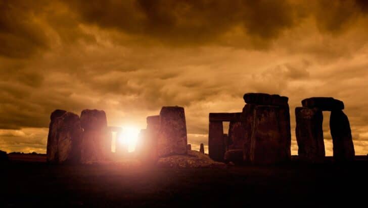 Stonehenge silhouetted against a dramatic sky at sunset