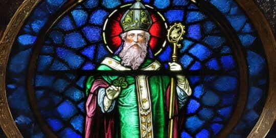 Stained glass window depicting Saint Patrick in traditional bishop attire holding a shamrock and a crosier