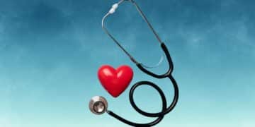 Stethoscope and red heart against a blue background representing health care themes