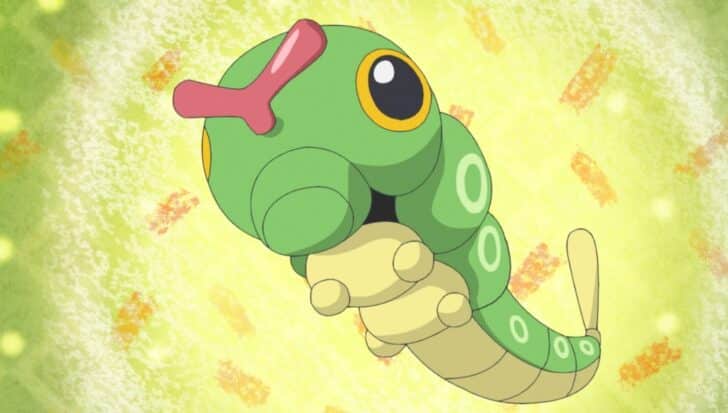 Caterpie, a green caterpillar-like Pokémon with large yellow eyes and circular markings, is shown in a dynamic pose against a light green and orange textured background.