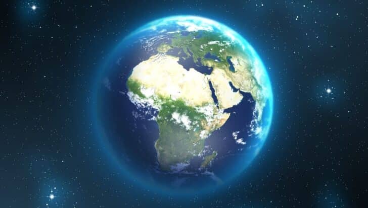 View of Earth from space highlighting continents and oceans surrounded by stars