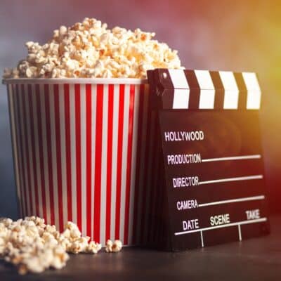 Tub of popcorn next to a director's clapperboard