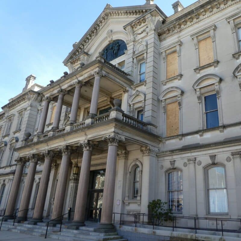Exterior view of the New Jersey State House with large pillars and a grand entrance