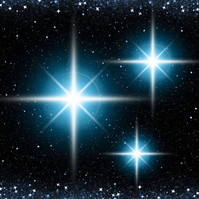 Three bright stars shining in the night sky, surrounded by numerous smaller stars