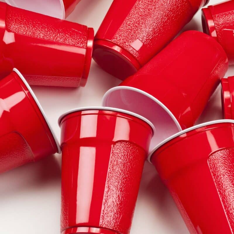 Red plastic Solo cups scattered on a white surface