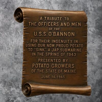 Bronze scroll plaque honoring USS O’Bannon officers and crew for using potatoes to help sink a Japanese submarine in 1943, presented by Maine potato growers