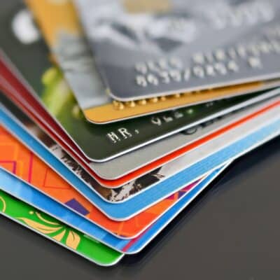 A stack of colorful credit cards with EMV chips