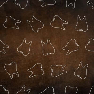 White line drawings of teeth on a textured dark brown background