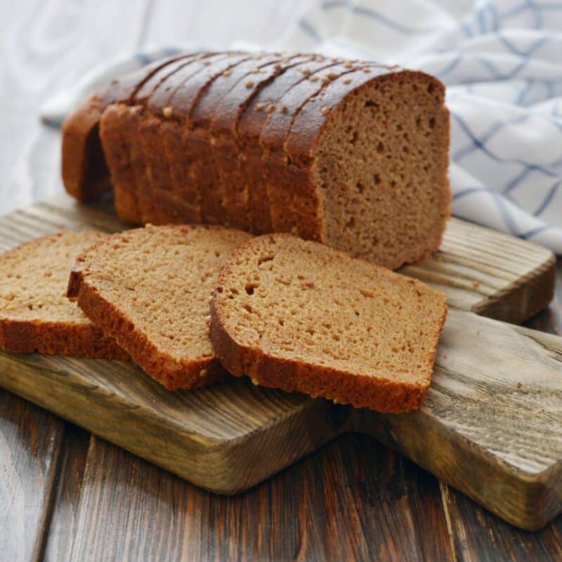 Sliced loaf of bread on a wooden cutting board