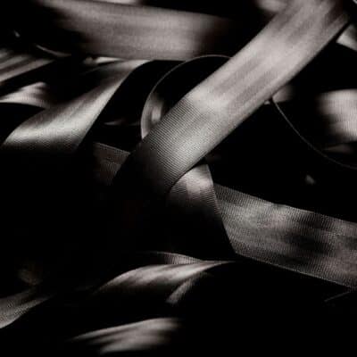 Close-up of a looped and intertwined black seatbelt