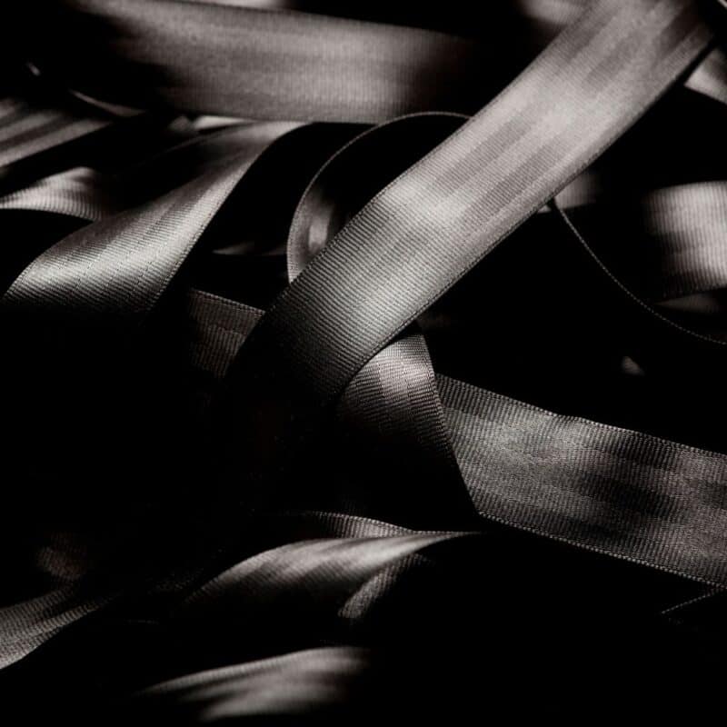 Close-up of a looped and intertwined black seatbelt