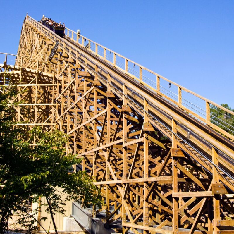 A wooden roller coaster with a steep incline