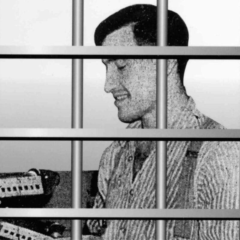 Joe Arridy smiling behind prison bars