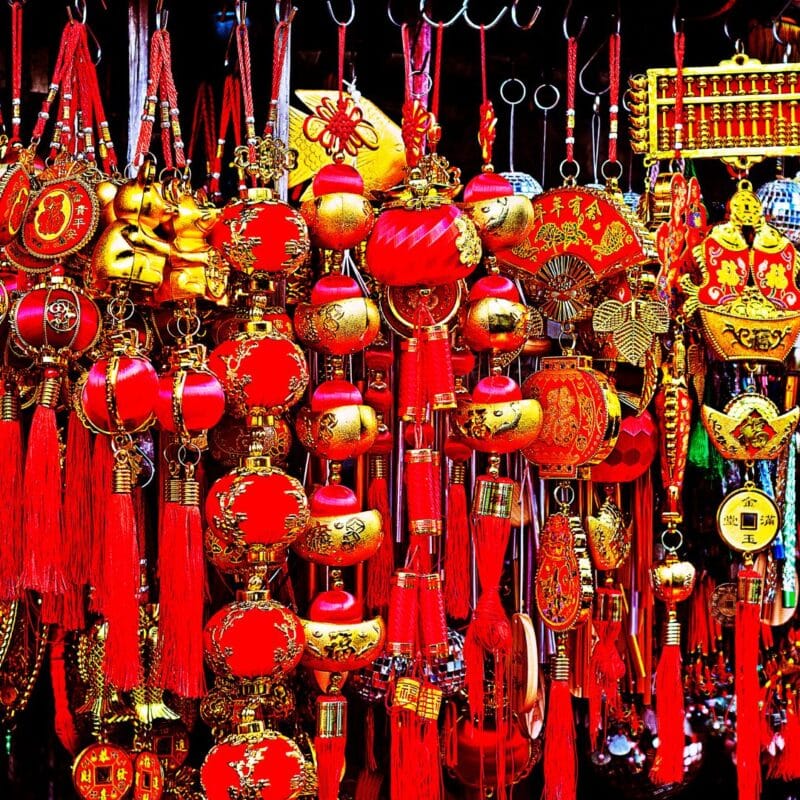 A variety of vibrant red and gold Chinese lucky charms and decorations