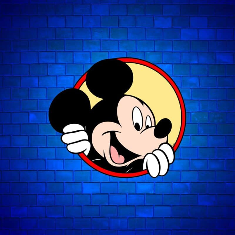 Mickey Mouse smiling and peeking through a round hole with a blue brick wall background