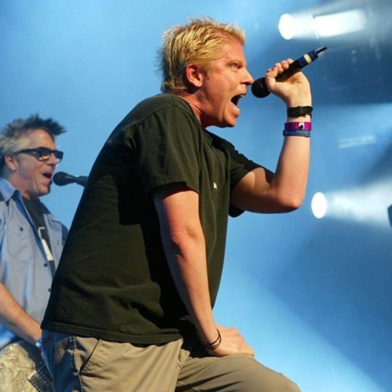 Dexter Holland passionately singing into a microphone