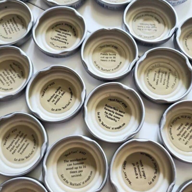 Assorted Snapple bottle caps displaying various "Real Facts" inside