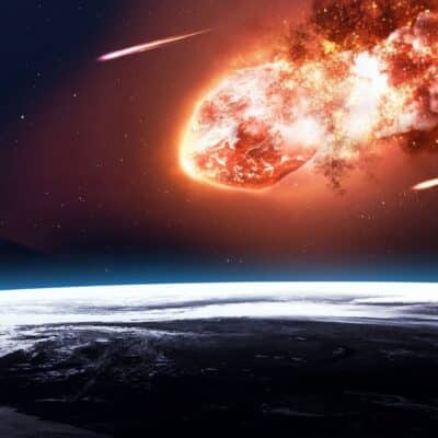 Massive meteor engulfed in flames entering Earth's atmosphere above frozen terrain