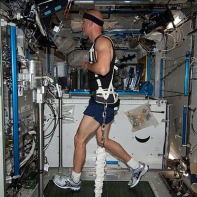 Astronaut running on a treadmill inside the International Space Station