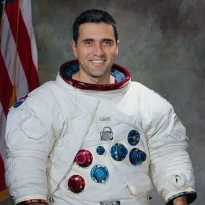 Harrison Schmitt in Apollo-white spacesuit with US flag behind