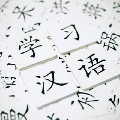 Flashcards with Chinese characters scattered on a surface