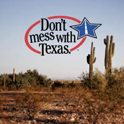 Desert landscape with cacti and ‘Don’t mess with Texas’ slogan