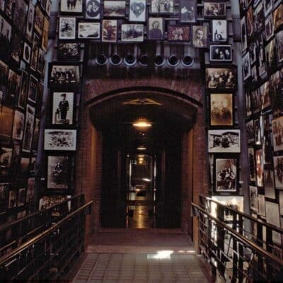 Hallway lined with historical Holocaust-era family photographs and portraits