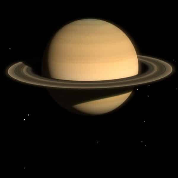 Saturn with its prominent ring system set against a starry black background